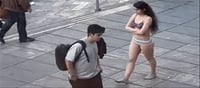 Where is the girl after taking off her clothes in protest...?